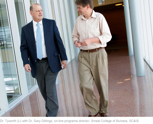 Gene Tyworth, Ph.D., chairman for the department of supply chain and information systems (SC&IS) at Penn State Smeal College of Business talking with Dr. Gary Gittings, on-line programs director, Smeal, SC&IS.